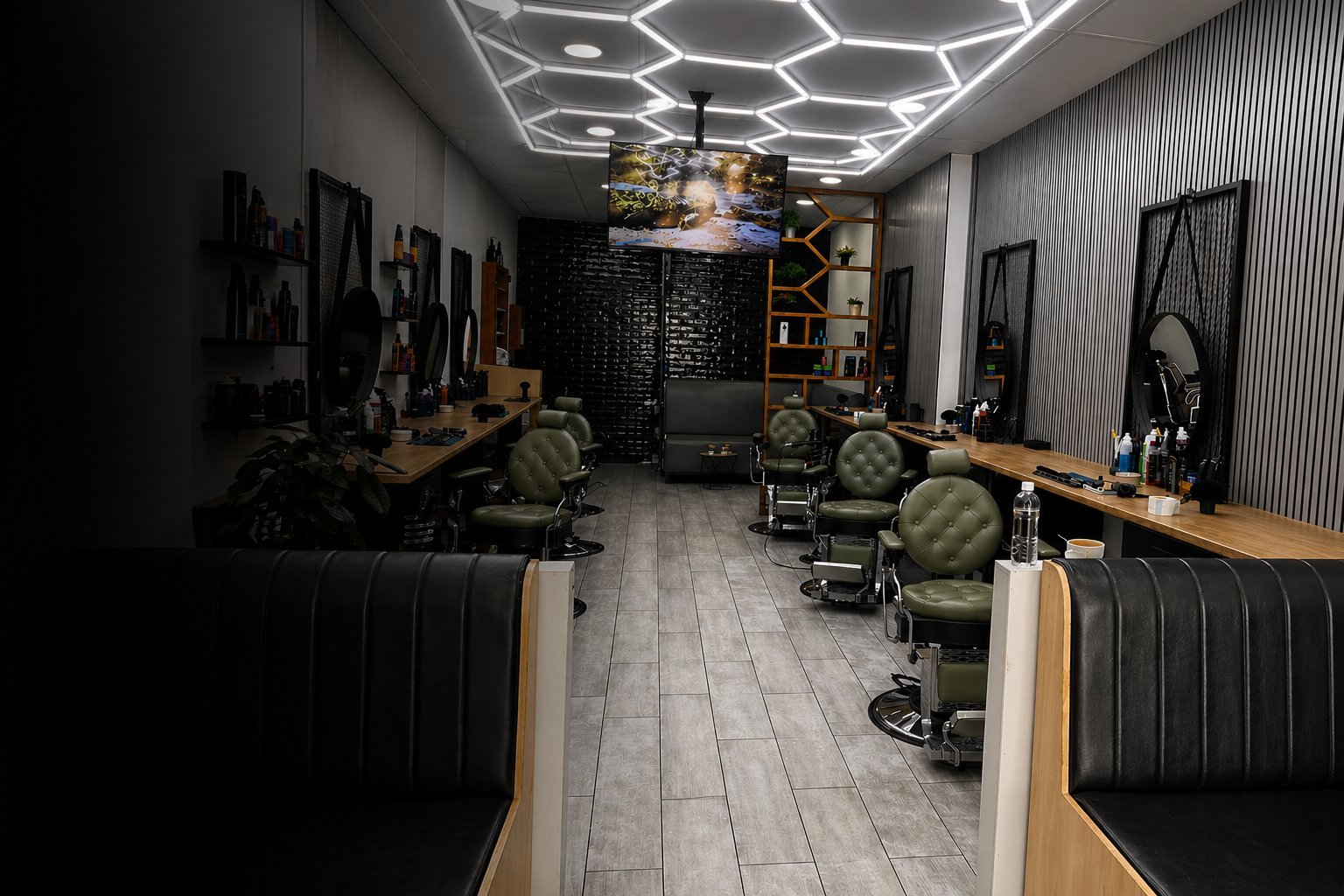 Modern barbershop interior with black and wood accents, barber chairs, hexagonal ceiling lights, and styling stations along both walls.